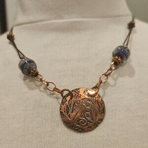 PENDANT, HANDMADE OF COPPER, LEATHER CORD AND GLASS BEADS